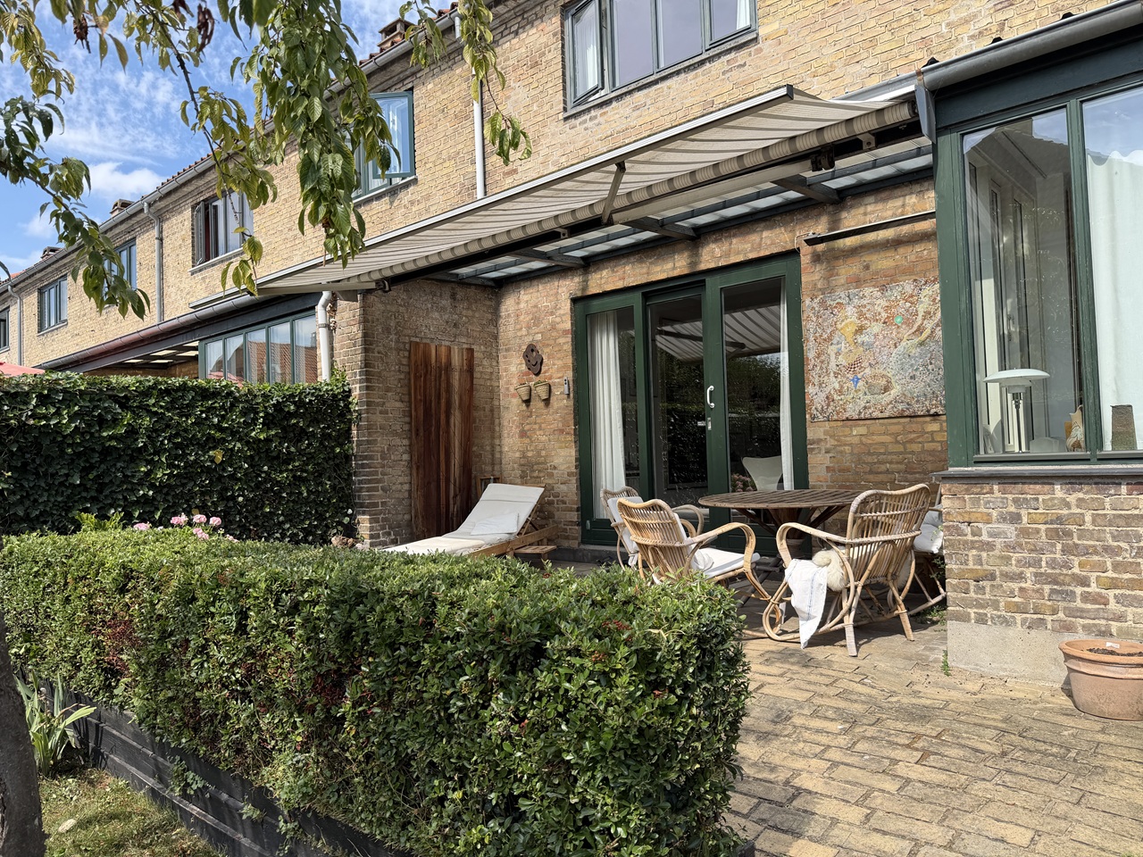 Terrasse og klippet hæk i rækkehushave på Frederiksberg efter dagens haveservice.